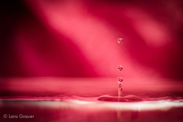 water droplet splash in front of a red background