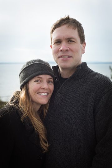 blonde women with beanie and man in black sweater posing with each other