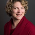 headshot of seattle area professional event consultant wearing a red sweater