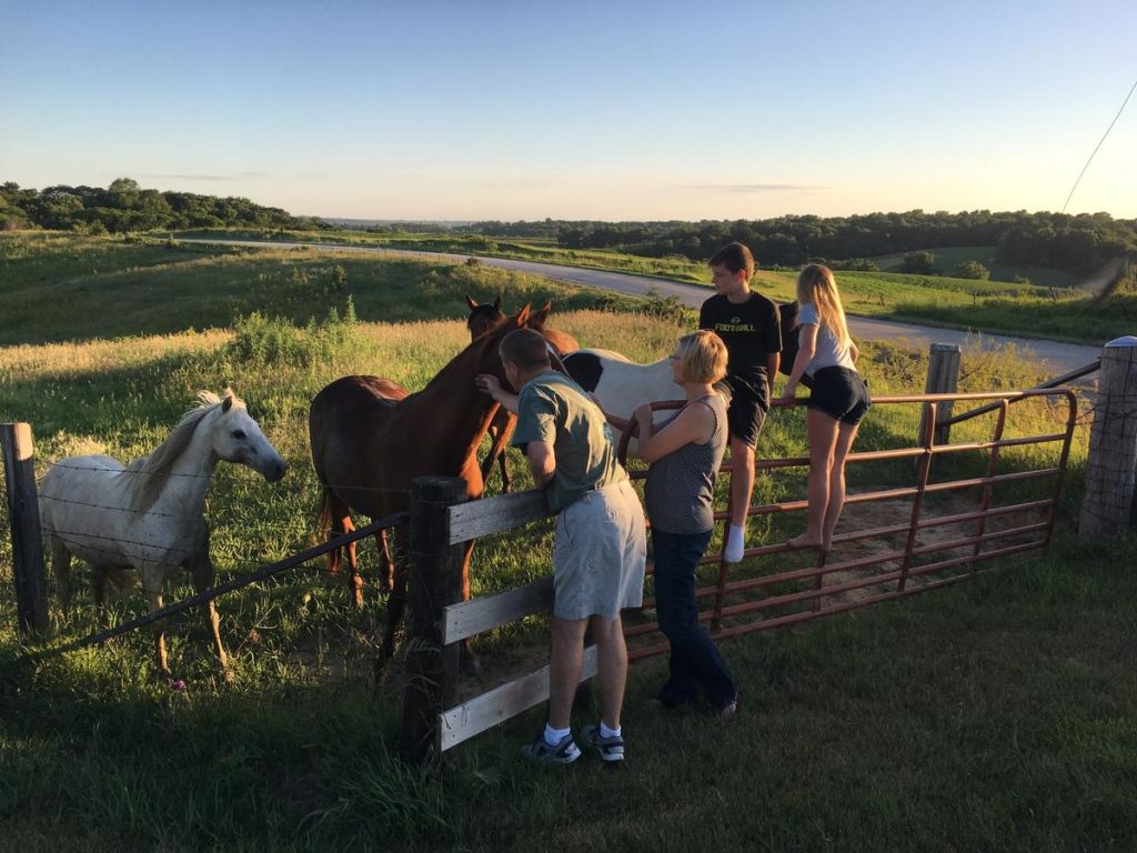 family preparing their horses for a photography shoot