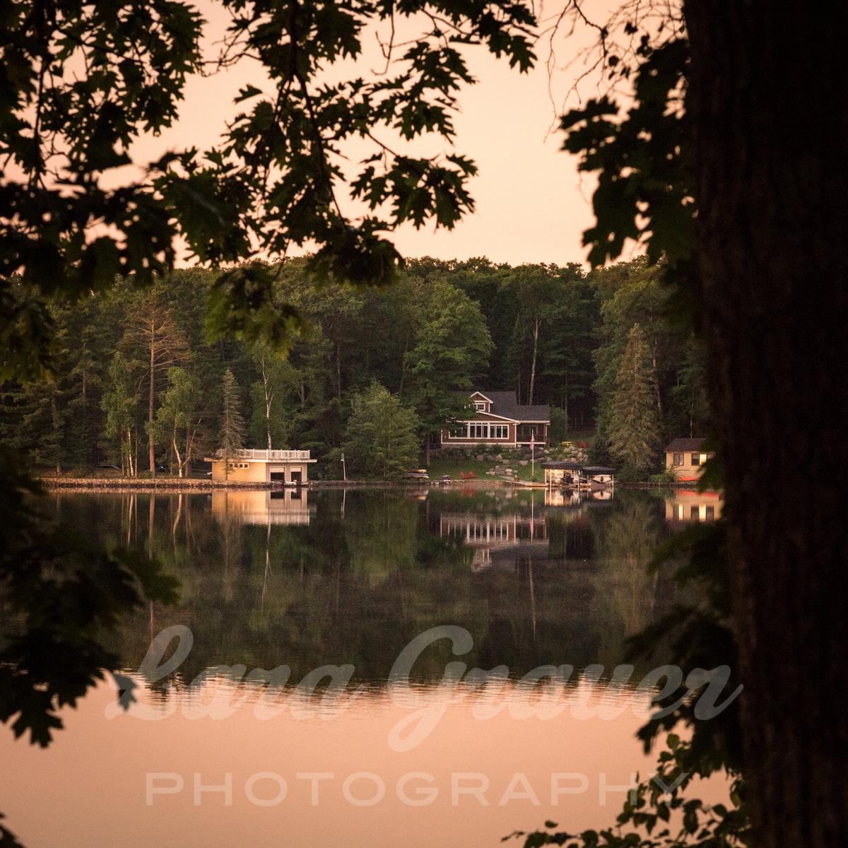 brown home on the side of the lake with the lara grauer photography logo