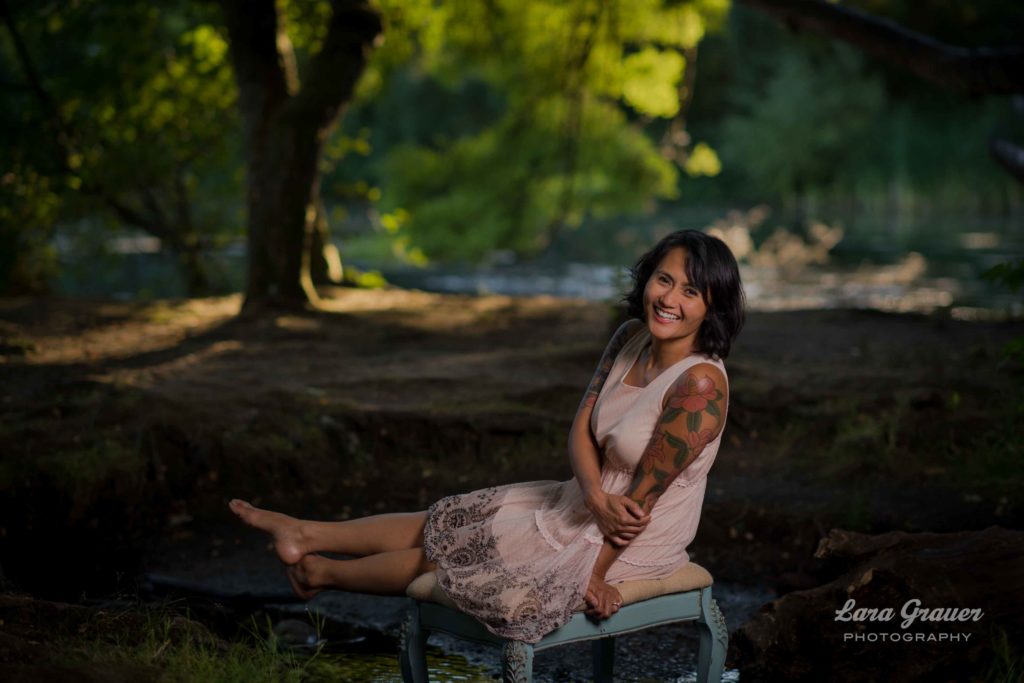 outdoor photo of a women sitting on a dressing stool with the lara grauer photography logo.