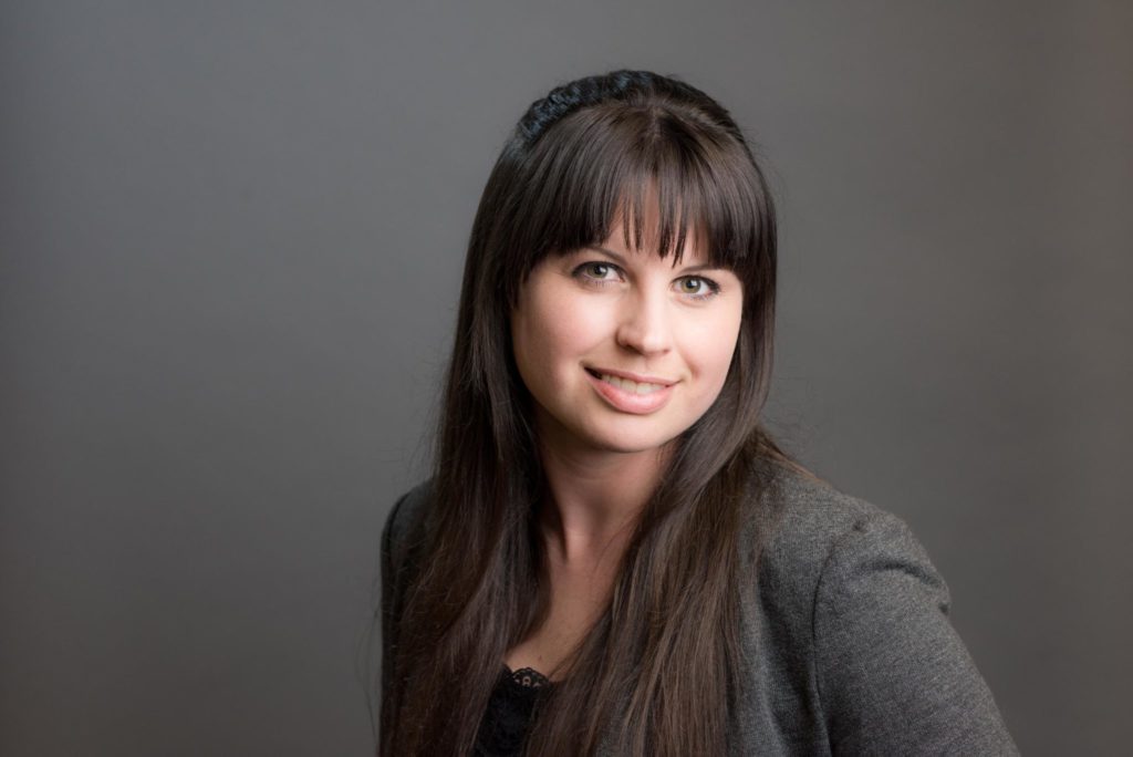 professional business headshot photo of female avian biologist in a gray top.