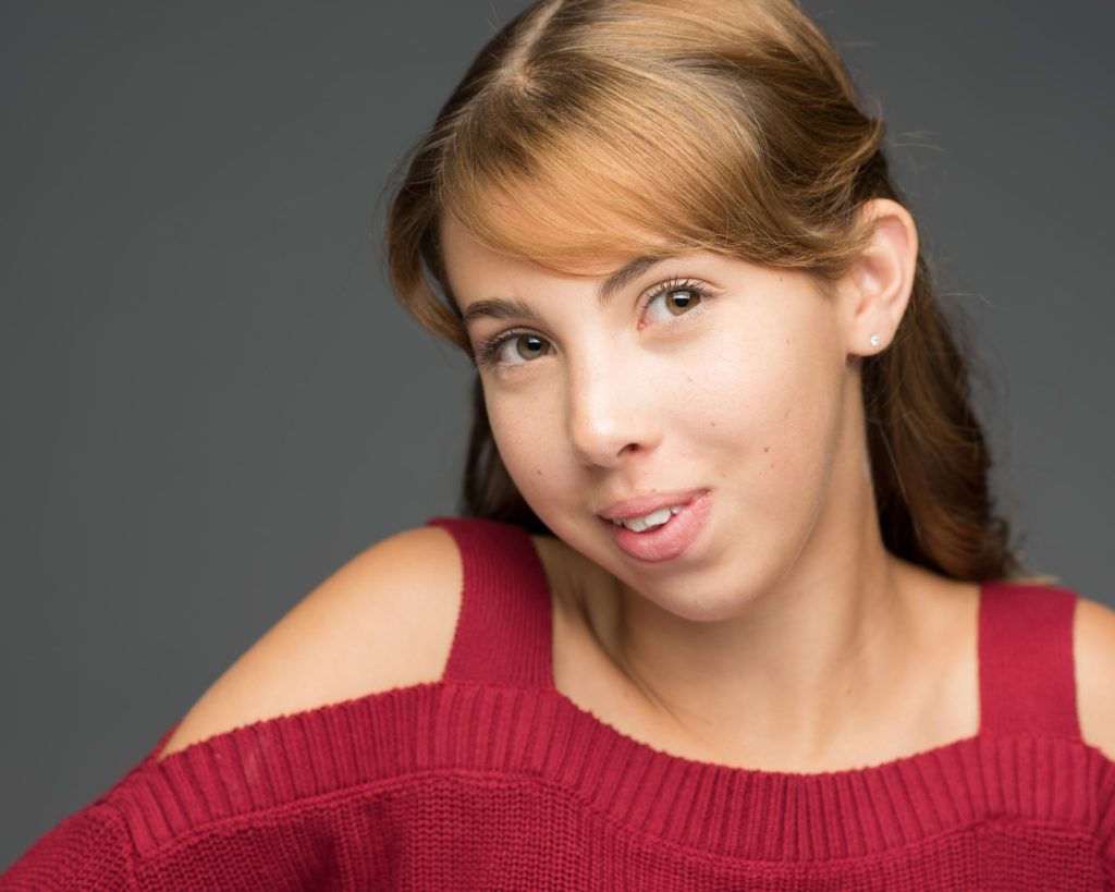 teenage girl with red top posing for the camera