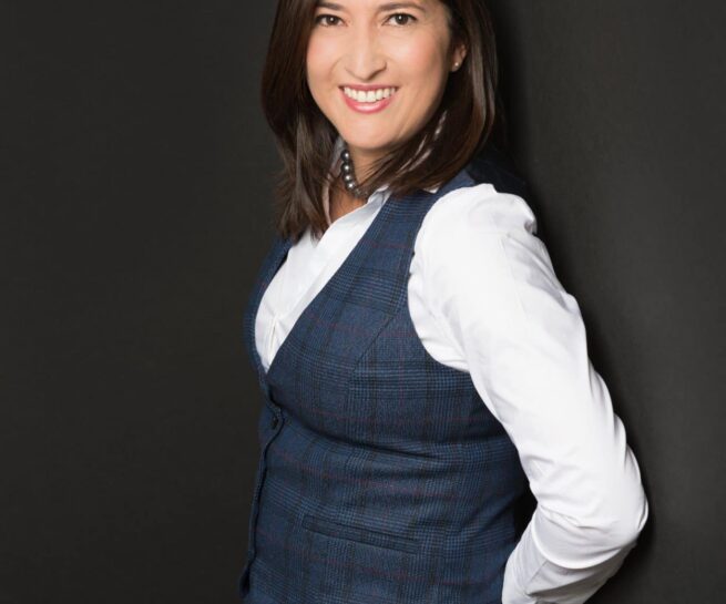 personal branding headshot photo of a public speaker in dark blue and white business casual.