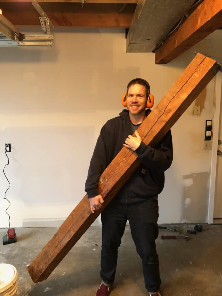 photo of a man holding an old and cracked post