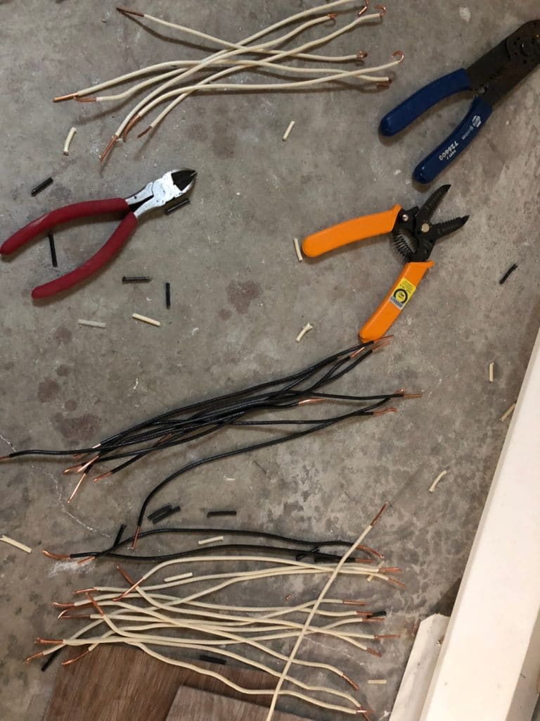 pliers, tweezers, cable cutters, and many assortments of cut black and white wires.