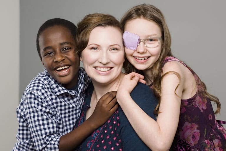 studio portrait of mother daughter and son