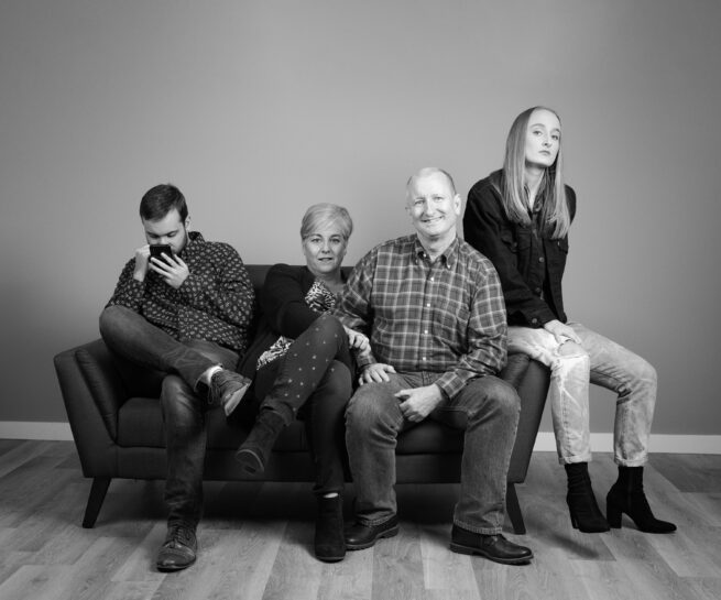 black and white photo of a family on a couch, part of Seattle Photographer Lara Grauer's "Generations" project