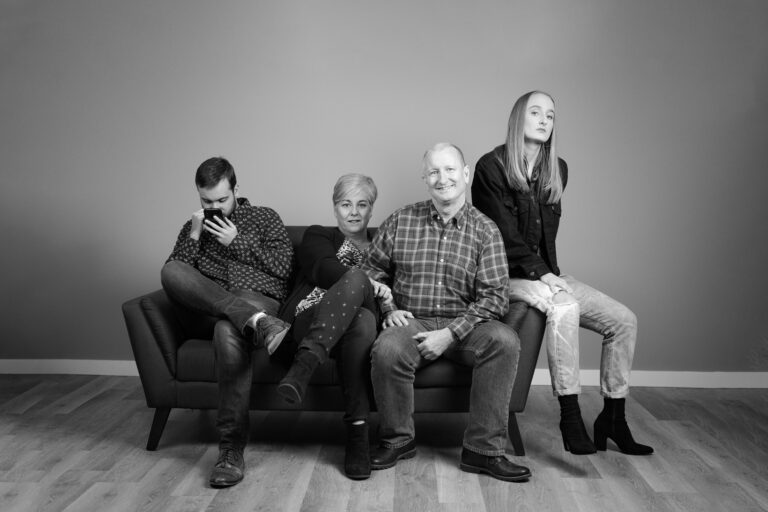 black and white photo of a family on a couch, part of Seattle Photographer Lara Grauer's "Generations" project