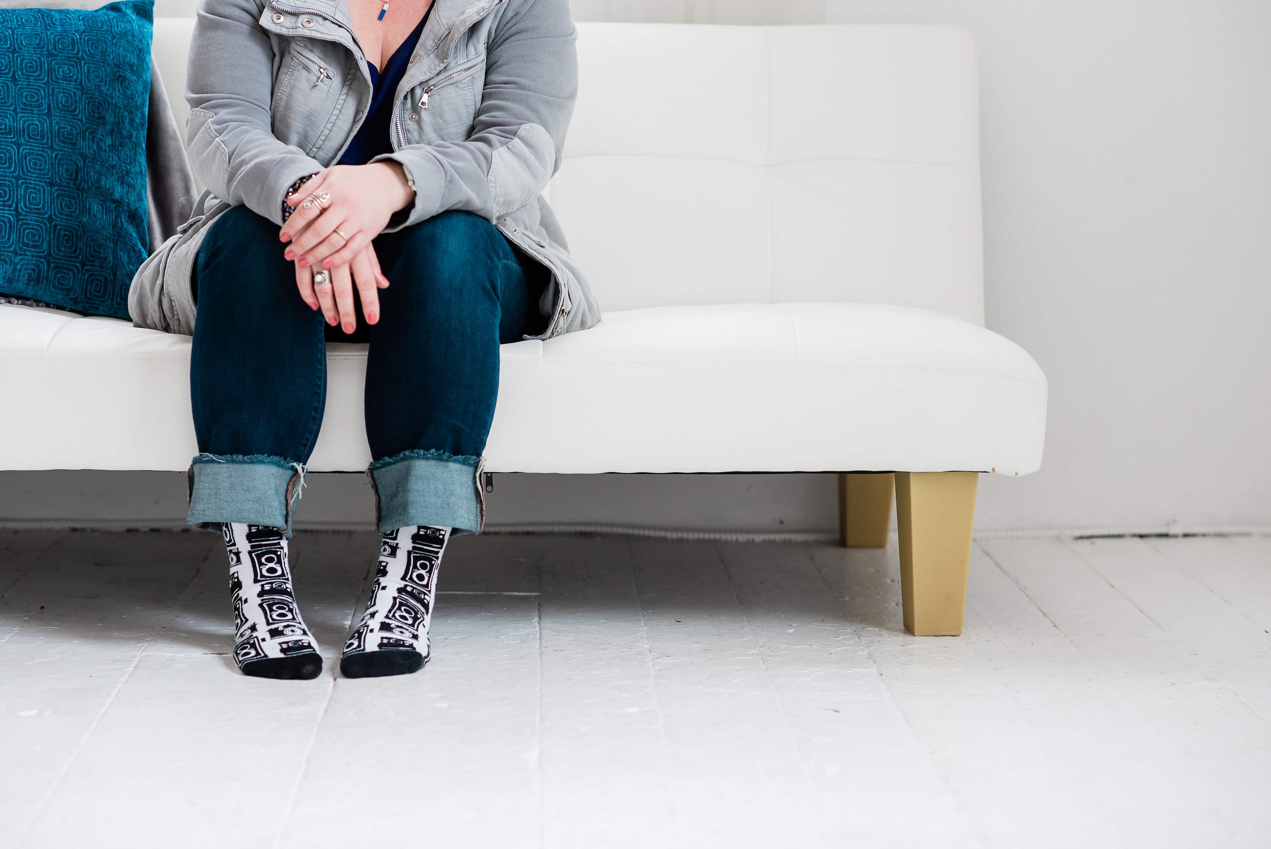 woman wearing trendy socks sitting on a sofa.