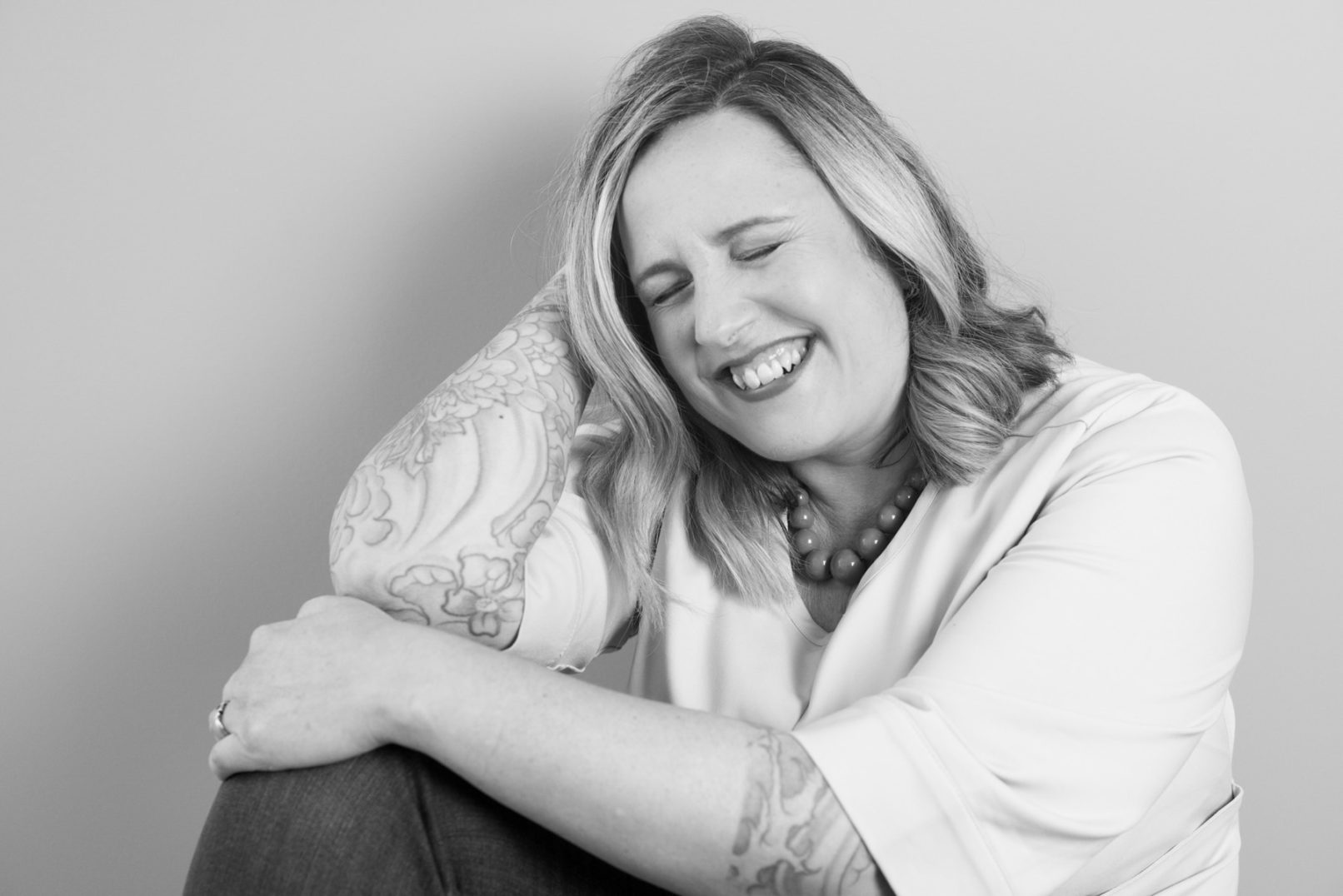 black and white of a middle-aged female sleep consultant smiling