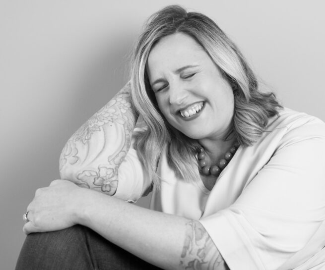 black and white of a middle-aged female sleep consultant smiling