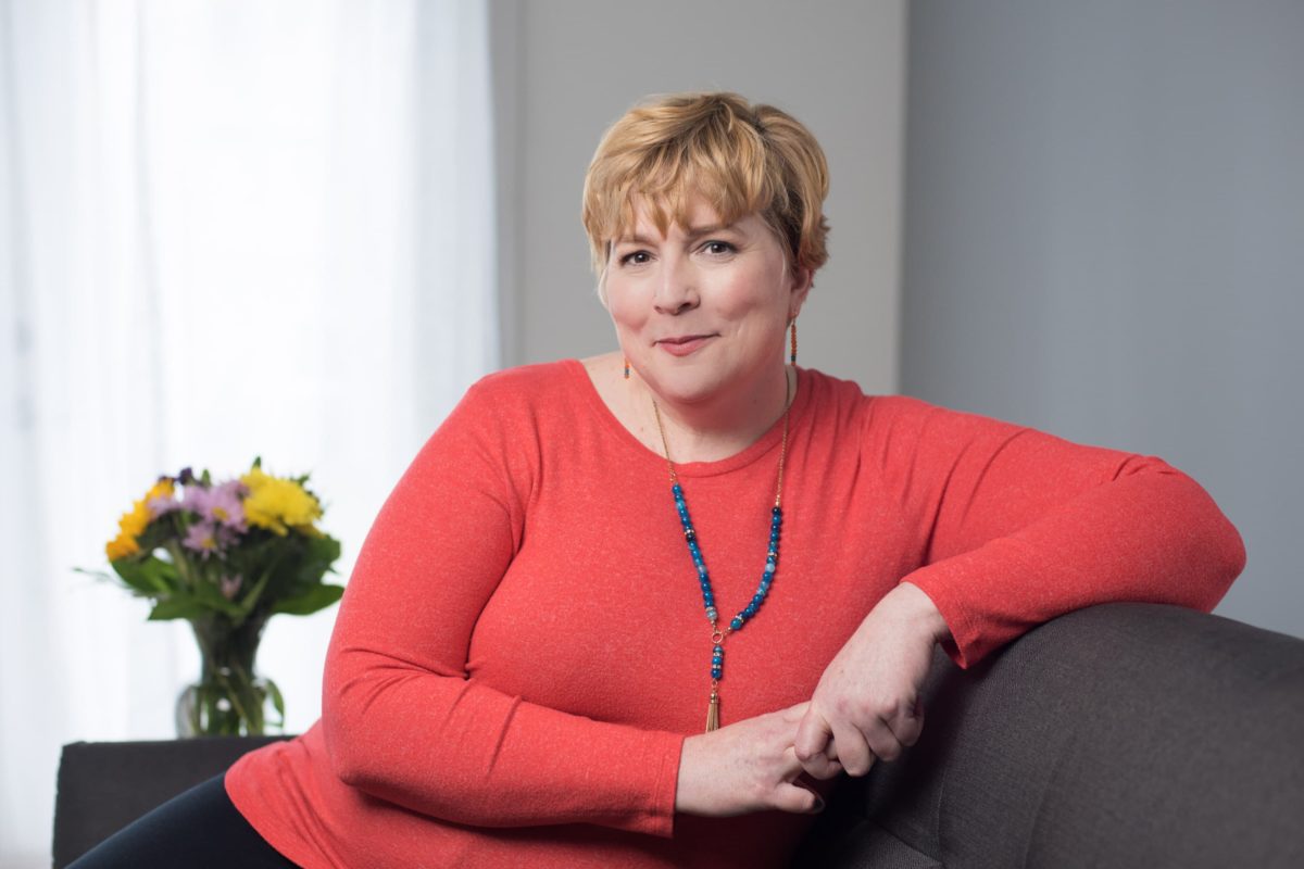 woman in Red Shirt Sitting On Couch - Personal Branding Photo