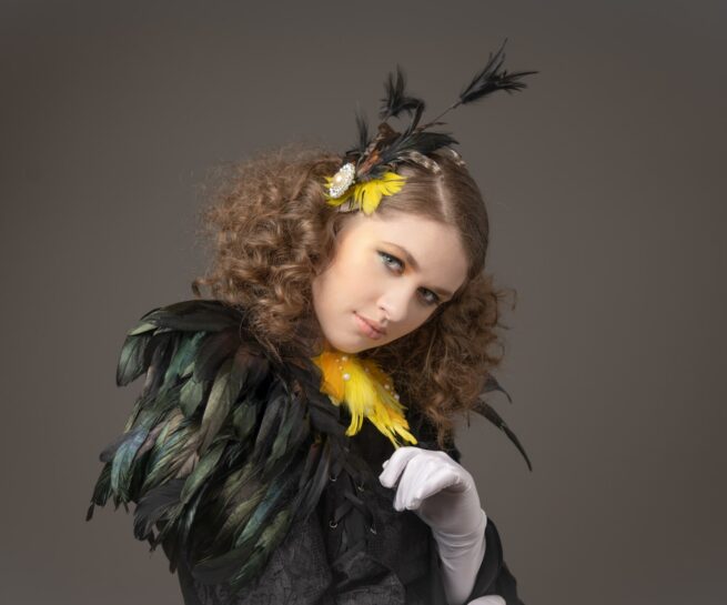 portrait of young lady wearing feathers and white gloves