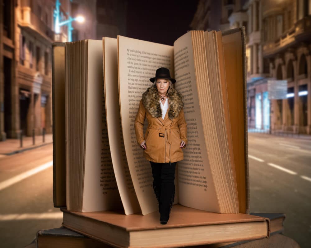 Fantasy image of woman walking out of an oversized old book, standing on a city street at night