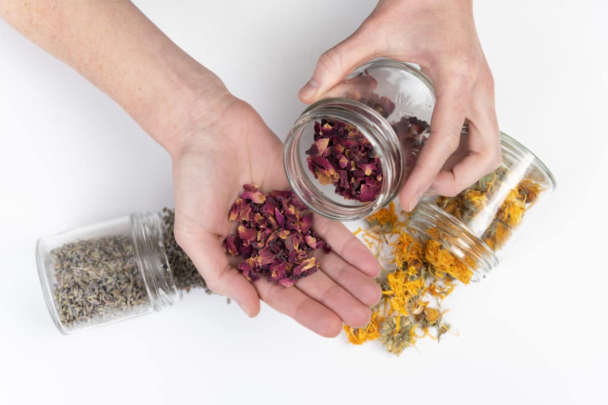 Spilled herbs, hands, jars