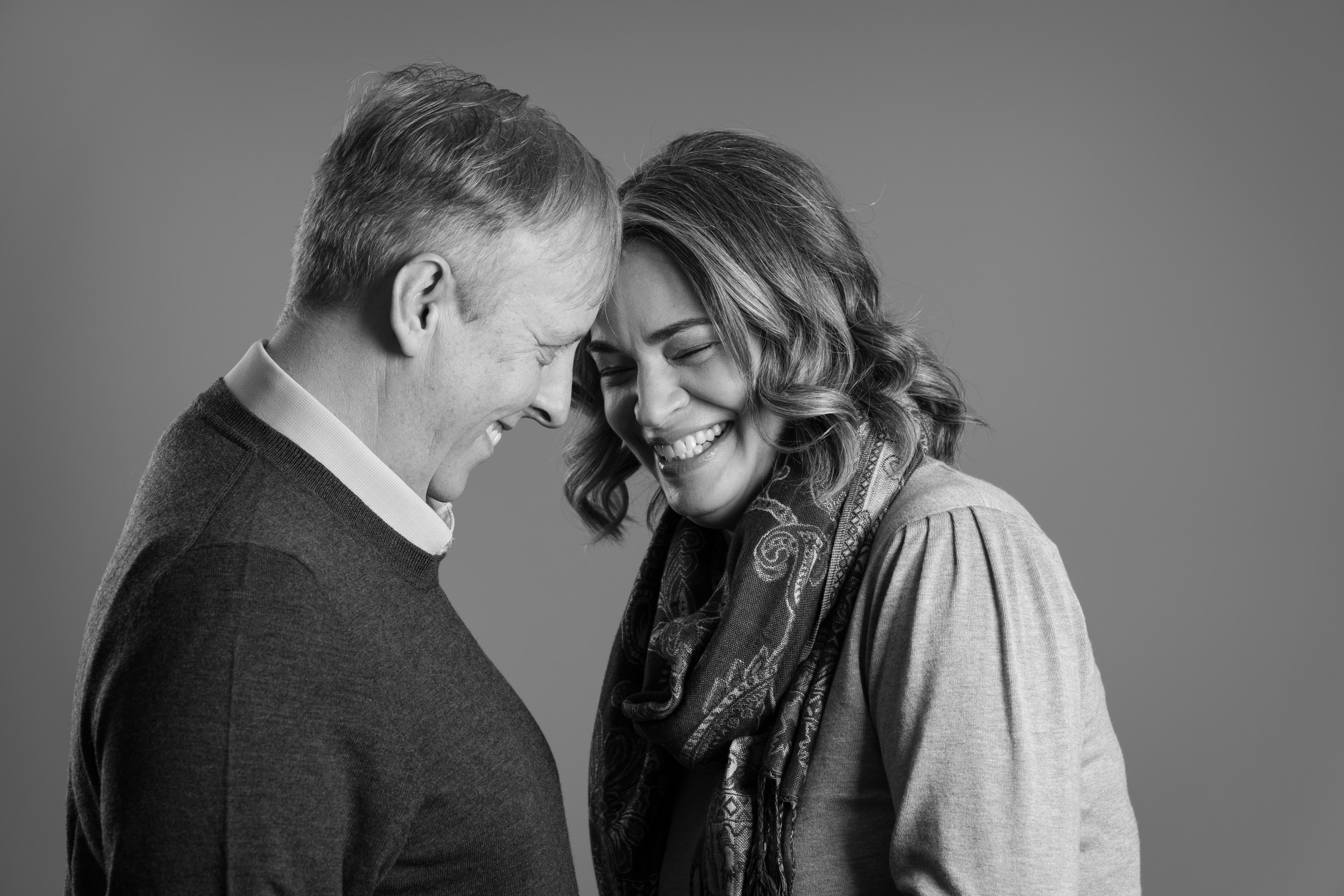 Black and white photo of a laughing couple