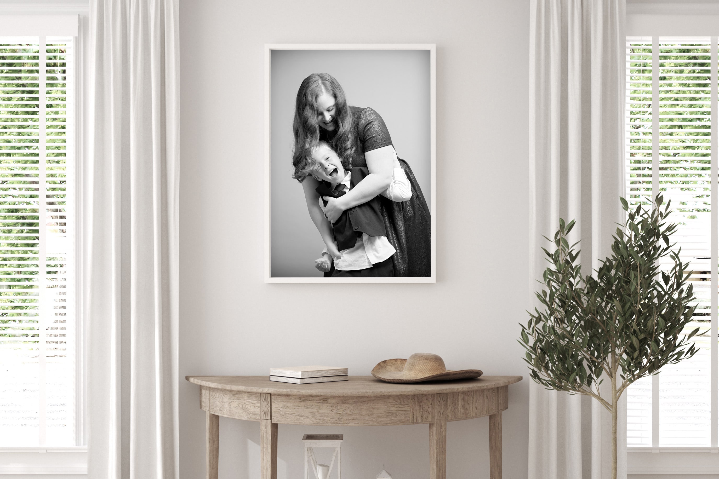 Portait of a mother and son hanging above a side table on the wall