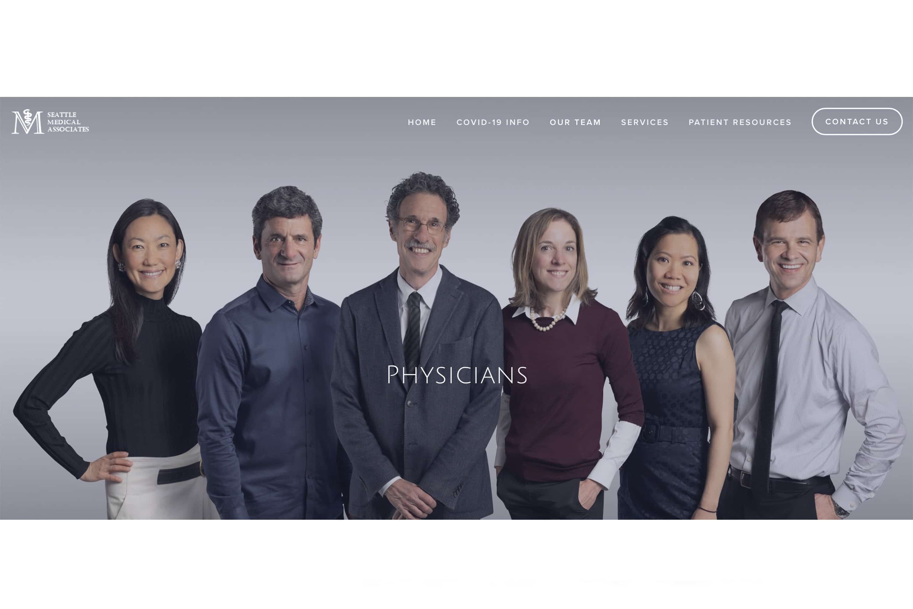 Group photo of physicians dressed formally and smiling for the camera.