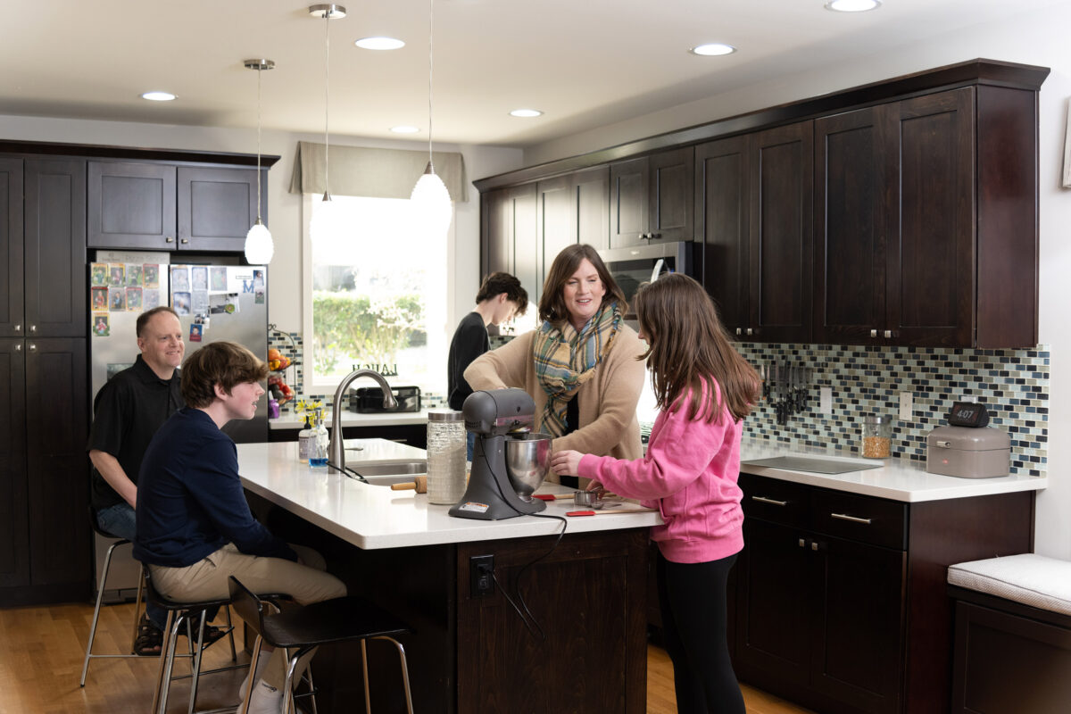 Photo of a family together in the kitchen