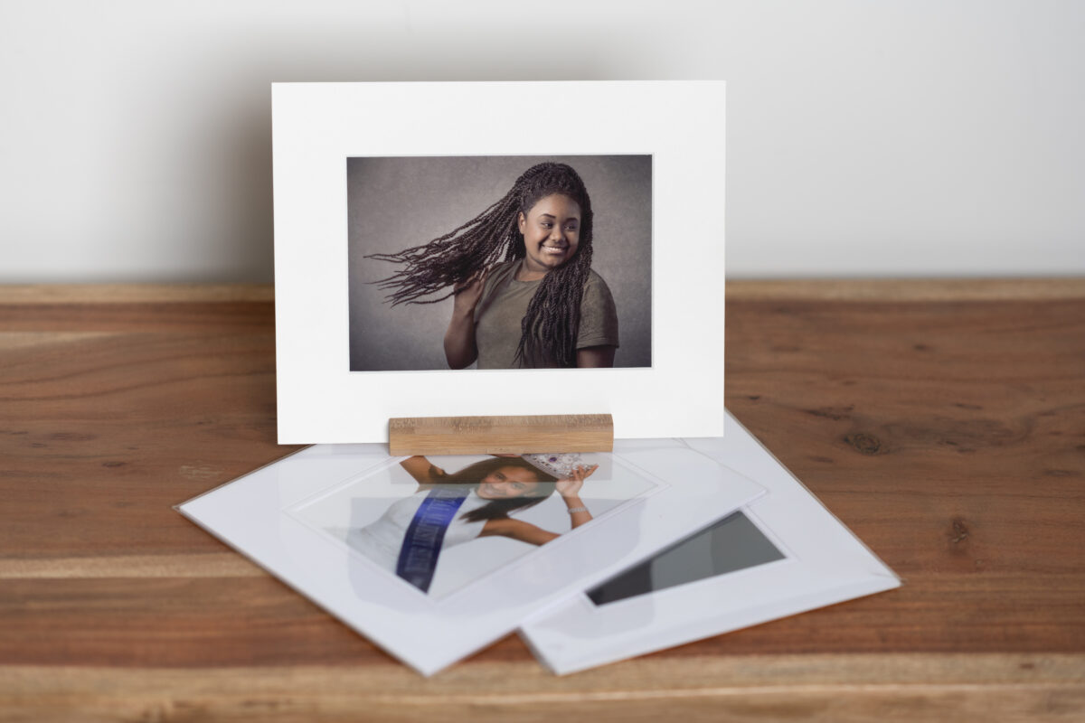 Matted Gift Photos - Lara Grauer Photography Matted gift photos displayed on wood table with white wall background.