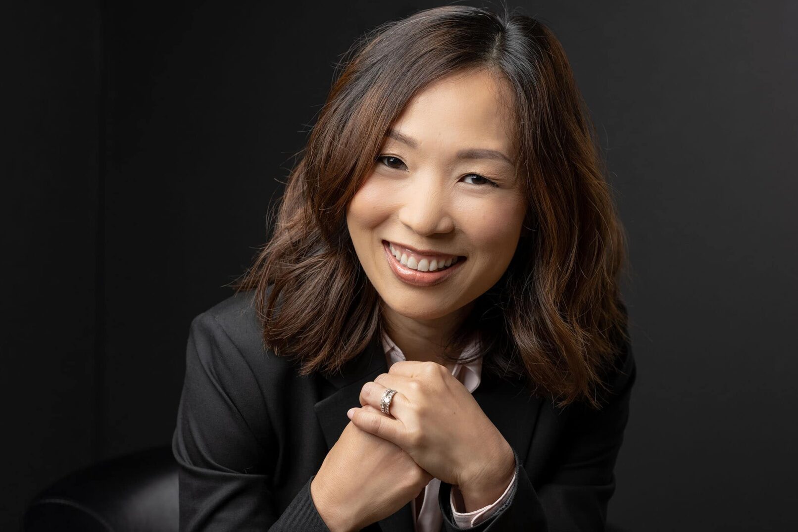 Woman wearing a suit, posing for headshot photo.